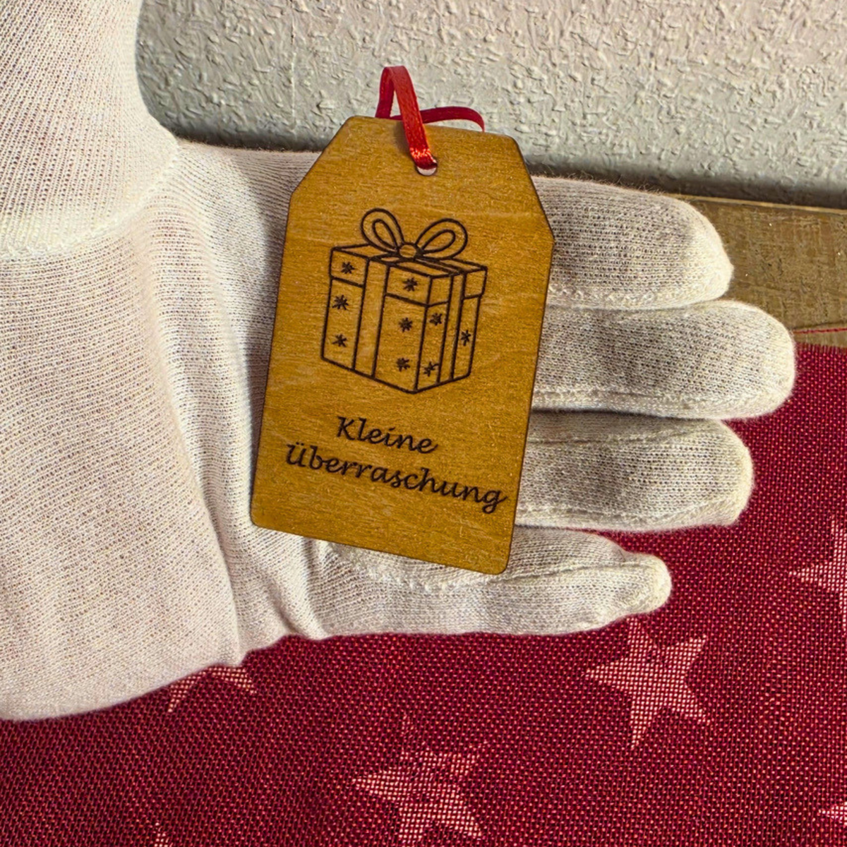 Geschenkanhänger aus Holz in der Hand